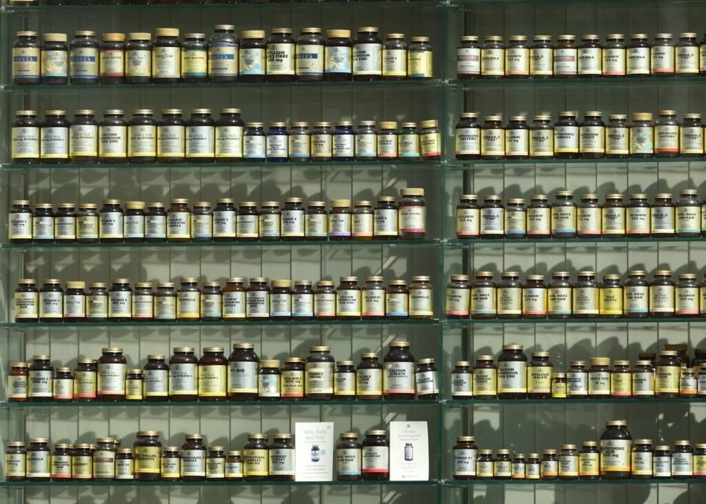 Labelled supplement bottles arranged on a display shelf