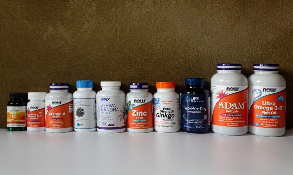 A row of supplement and vitamin bottles on a shelf