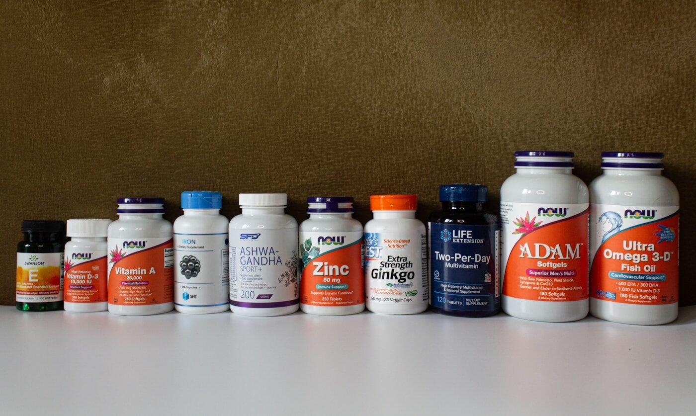 A row of supplement and vitamin bottles on a shelf