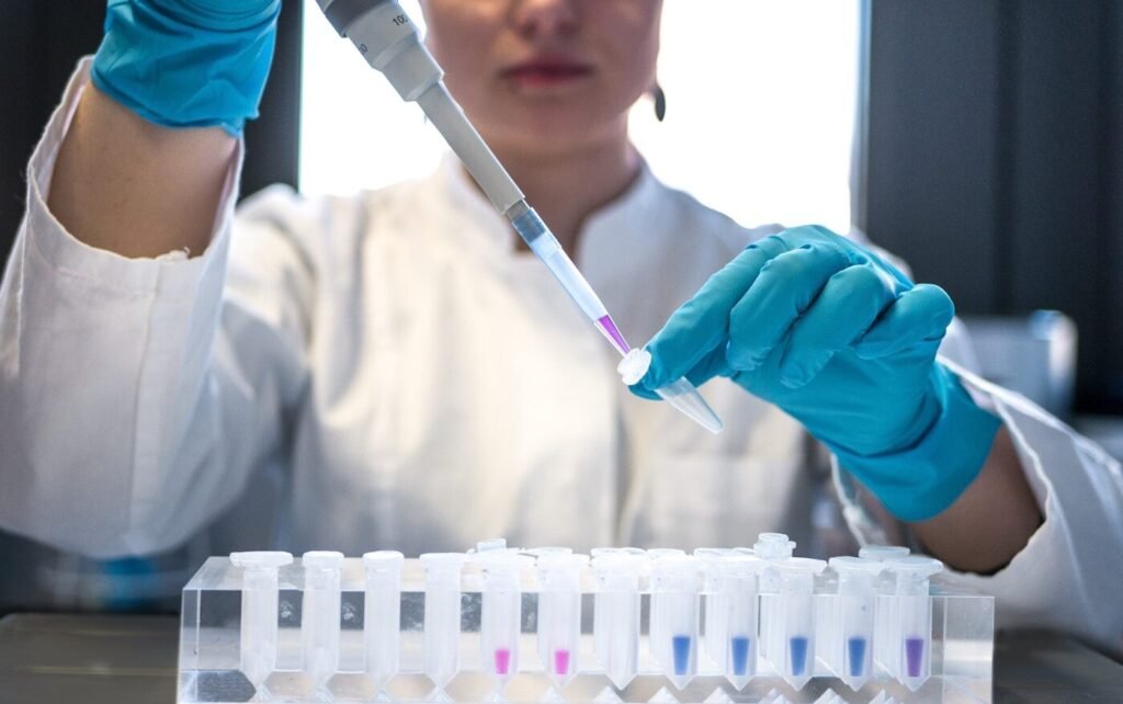 Scientist using a pipette with test tubes in a laboratory