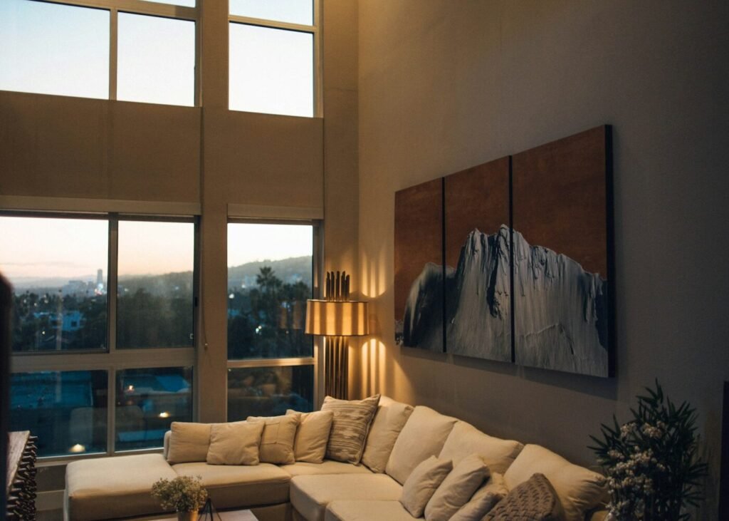A grey chaise couch beside a window