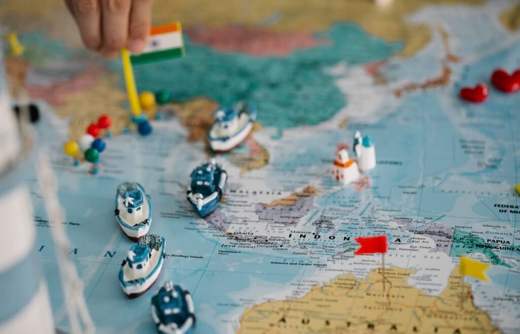 World map marked with pins and model ships, representing market selection for international eCommerce