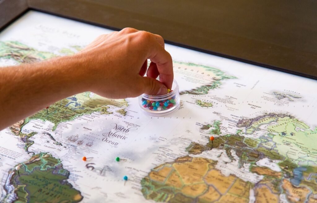 Marking target markets with pins on a world map during expansion planning