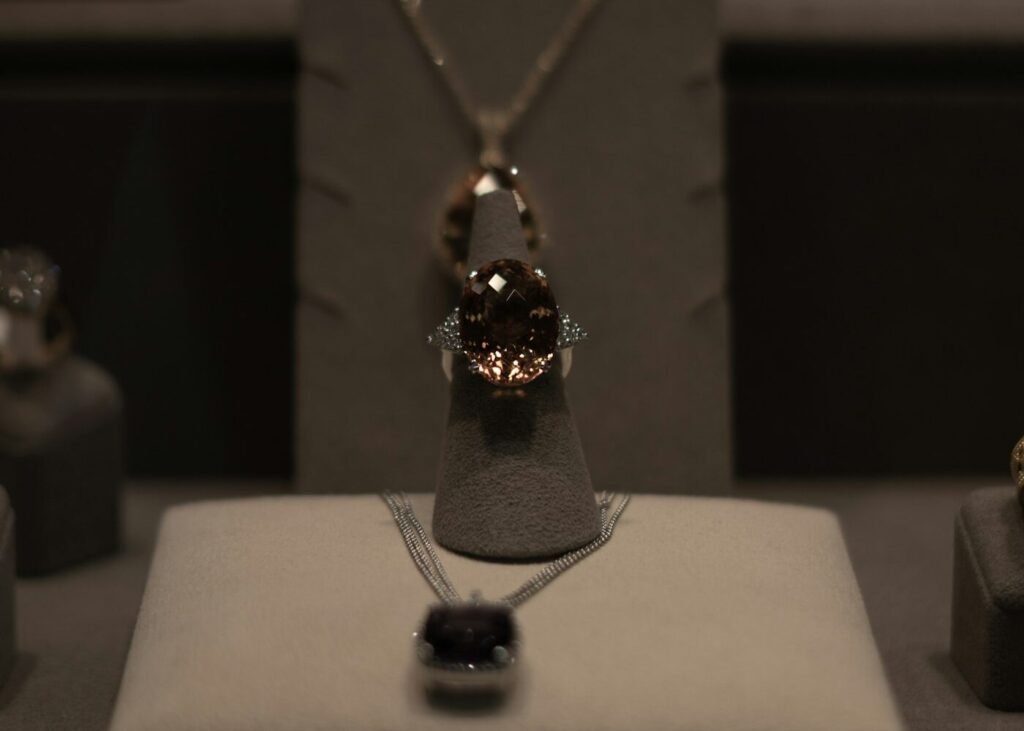 A necklace and ring photographed in close detail