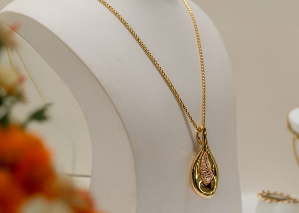 A necklace displayed on a white mannequin