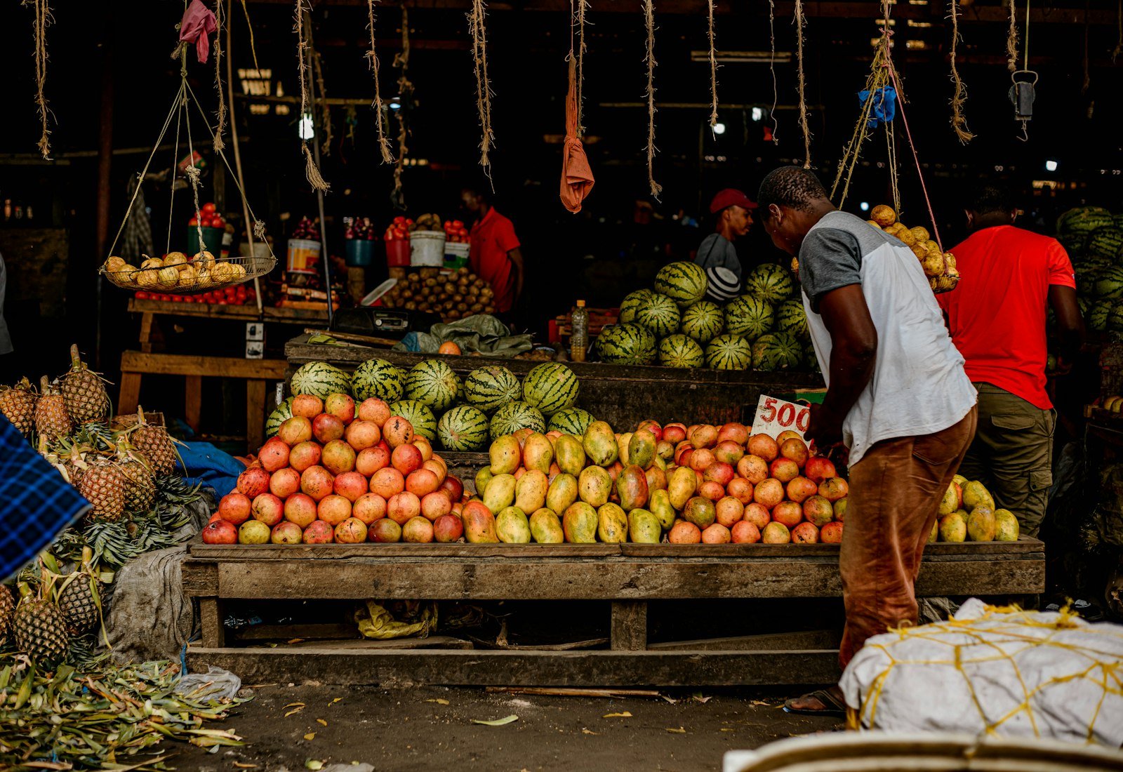 Trader standing at a produce stall in an African market