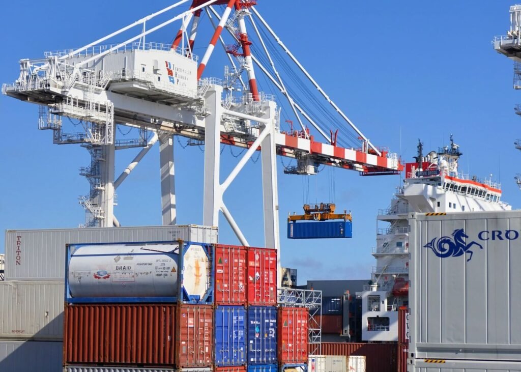 Colourful shipping containers stacked in a busy port