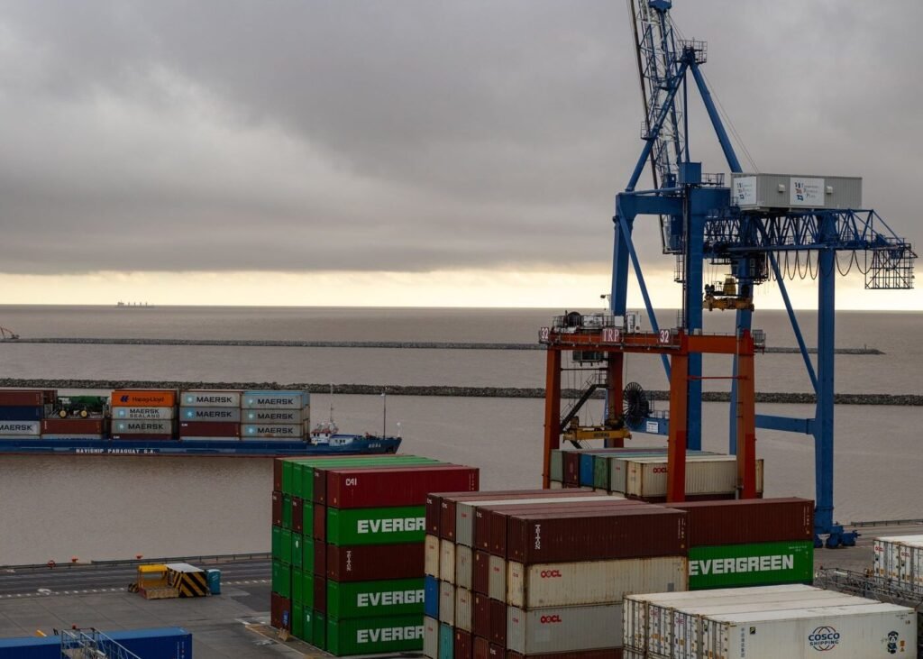Shipping port with stacked cargo containers and cranes