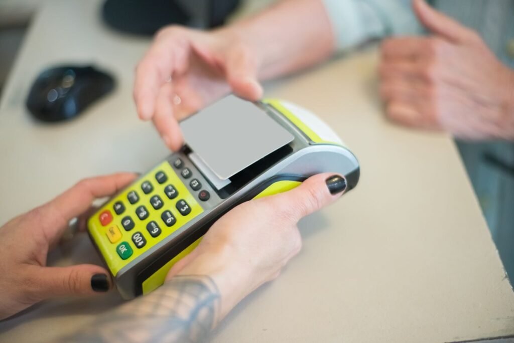 Customer paying by card at a checkout terminal