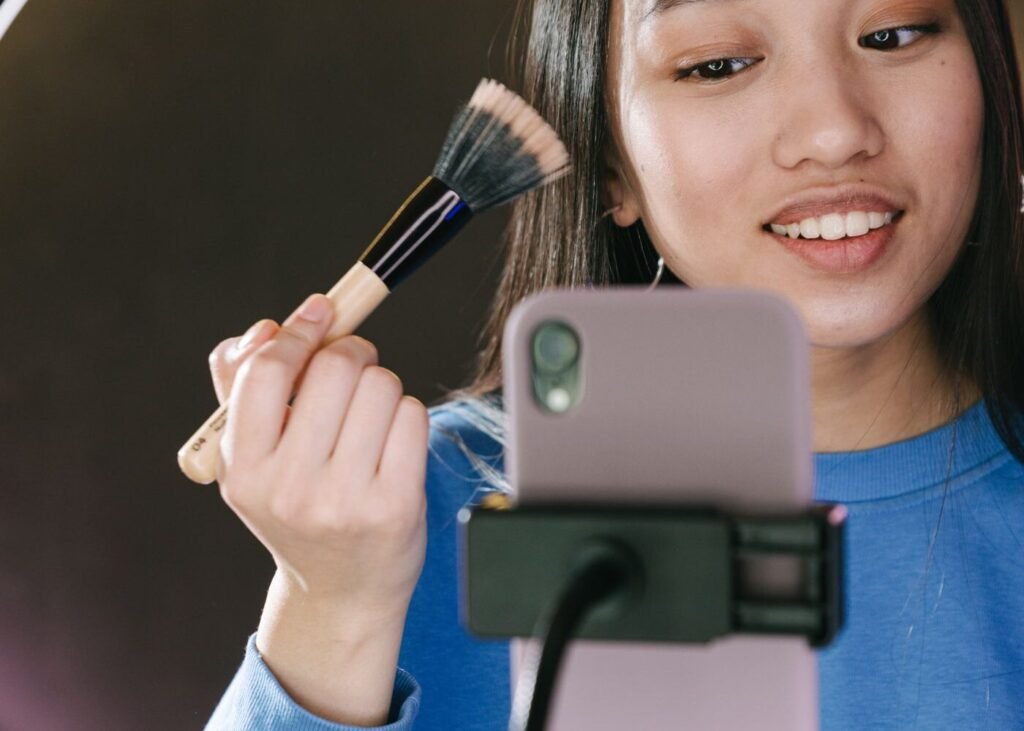 Creator filming a product with a phone and ring light