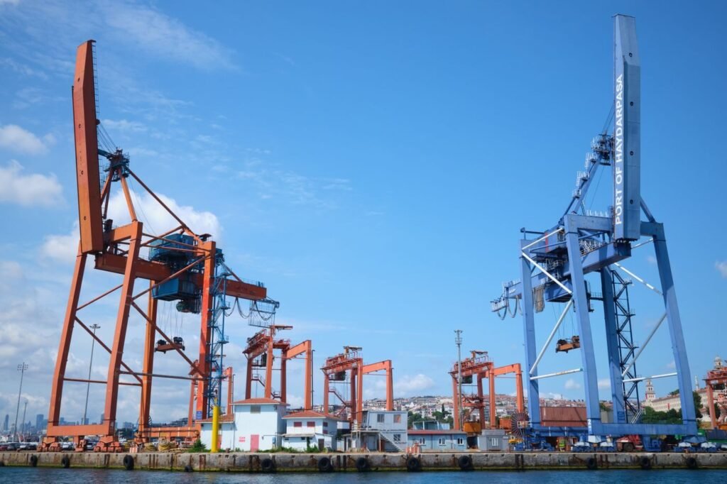 Industrial port cranes under a clear blue sky