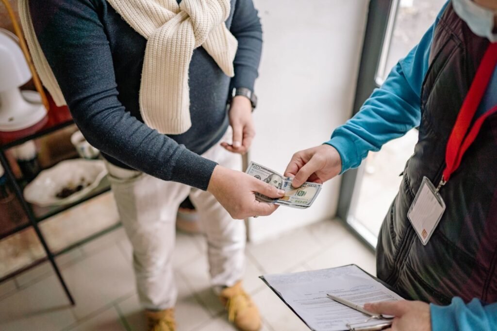 Hands exchanging cash during a transaction