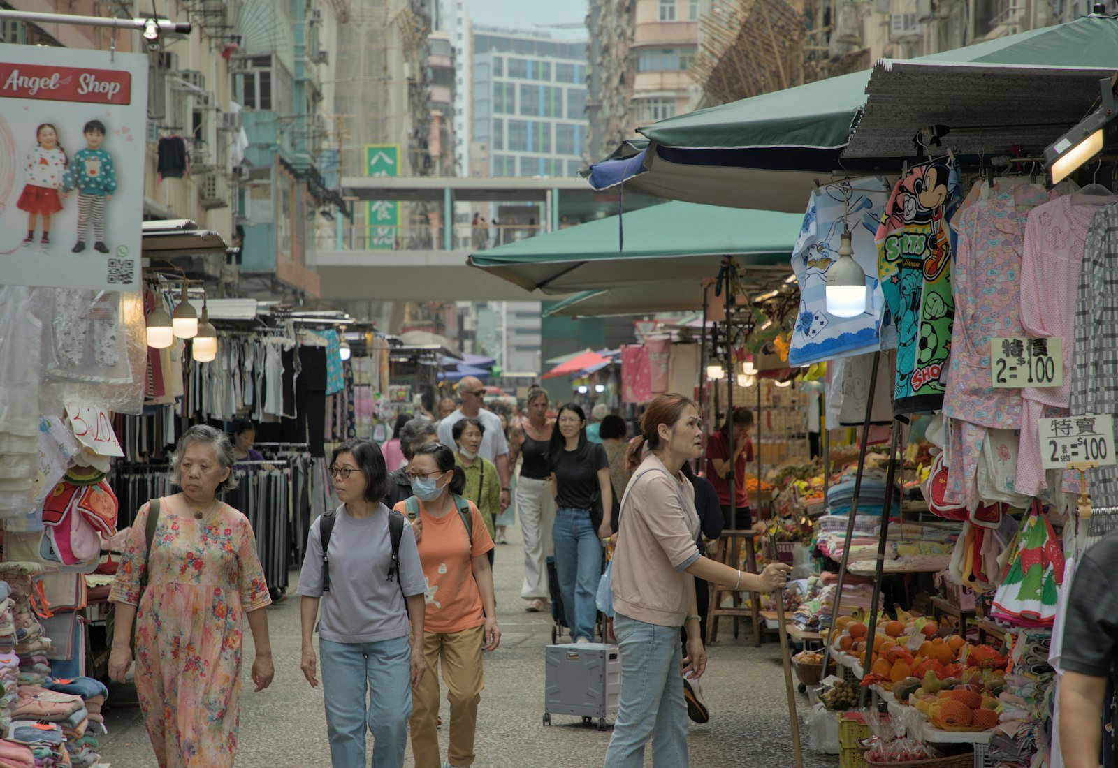 Shoppers walking through a busy outdoor market