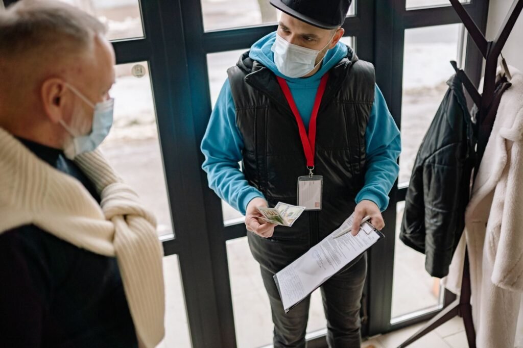 Delivery courier receiving a cash payment from a customer