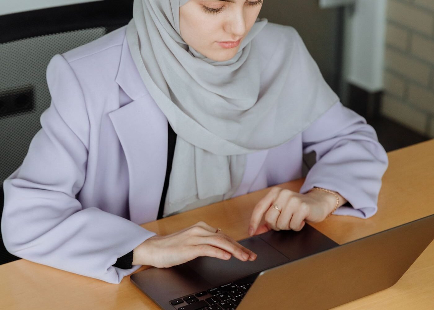 Professional reviewing eCommerce performance on a laptop in a MENA office