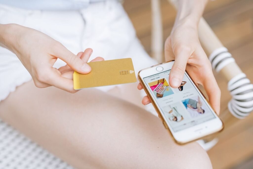 Shopper holding a smartphone and a payment card