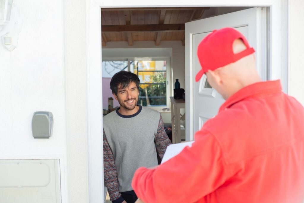 Delivery courier handing a package to a customer