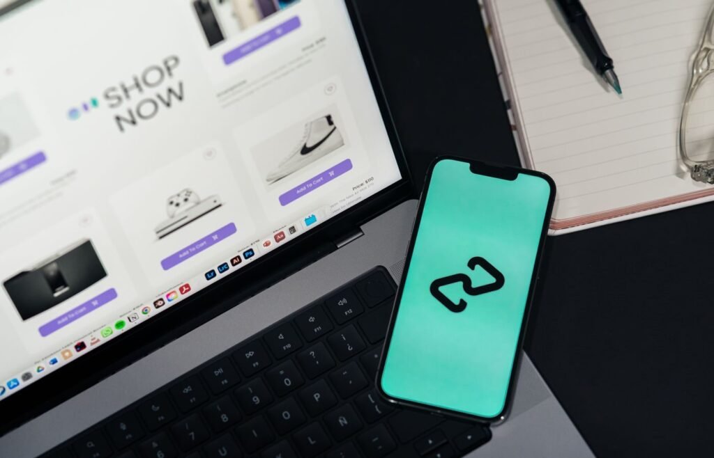 Smartphone and laptop showing two online storefronts side by side, representing an eCommerce channel mix