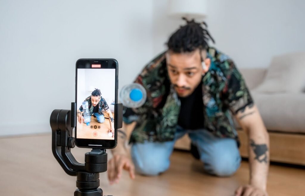 Marketer filming a short product video on a smartphone gimbal for paid social creative