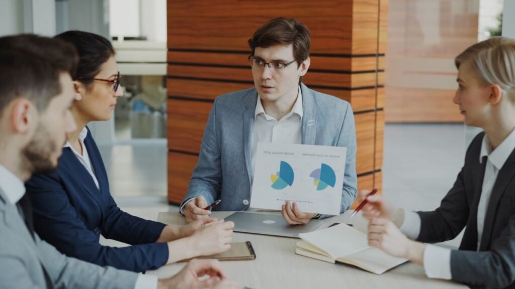 eCommerce team discussing strategy and reporting around a meeting table