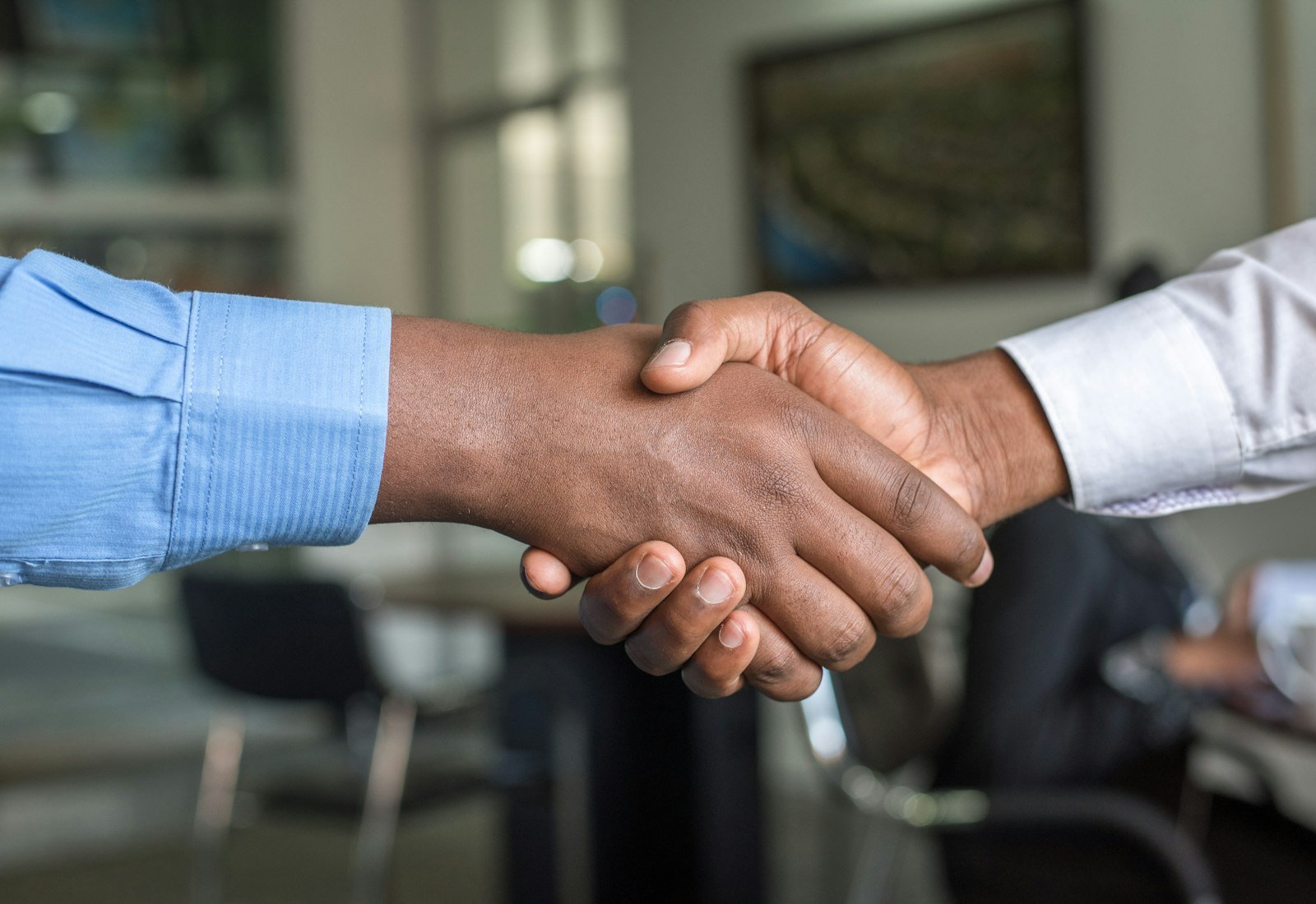 Two people shaking hands on a partnership agreement