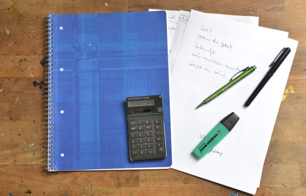 Notebook and office supplies on a desk set out for quarterly budget planning