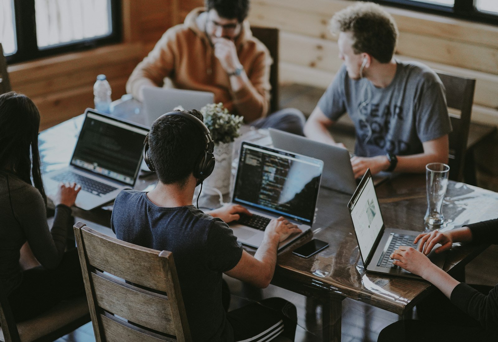 Team working together on laptops around a table