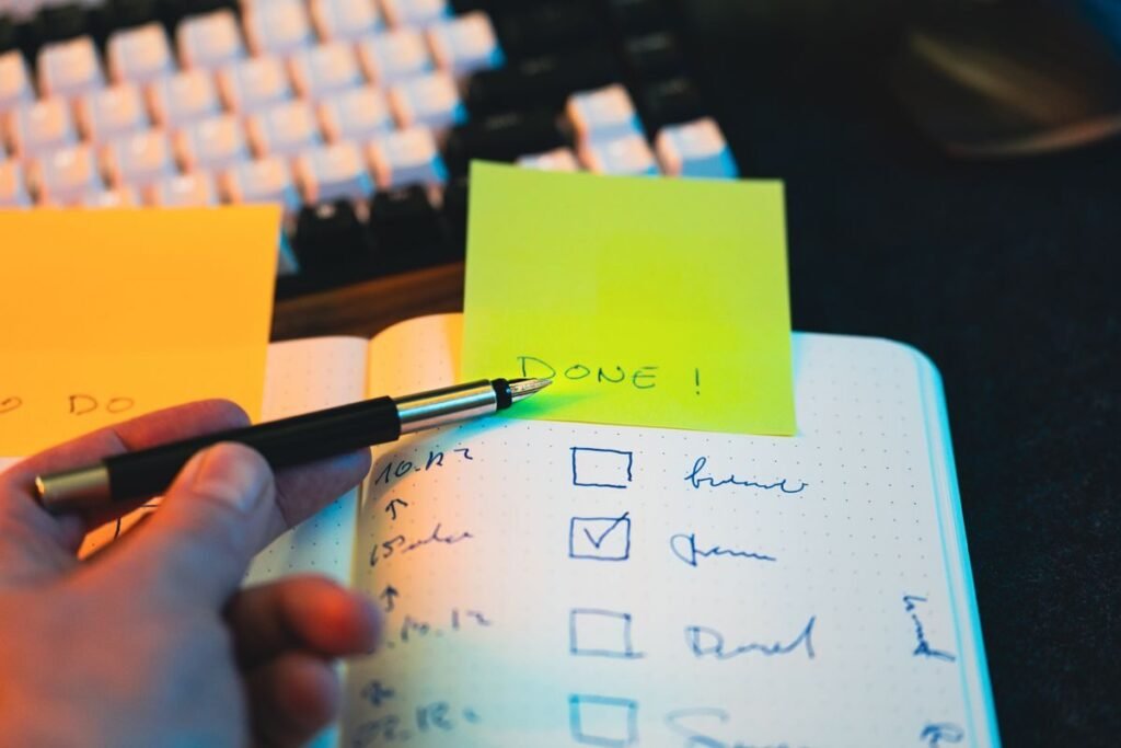 Marking off a completed step on a written checklist with sticky notes