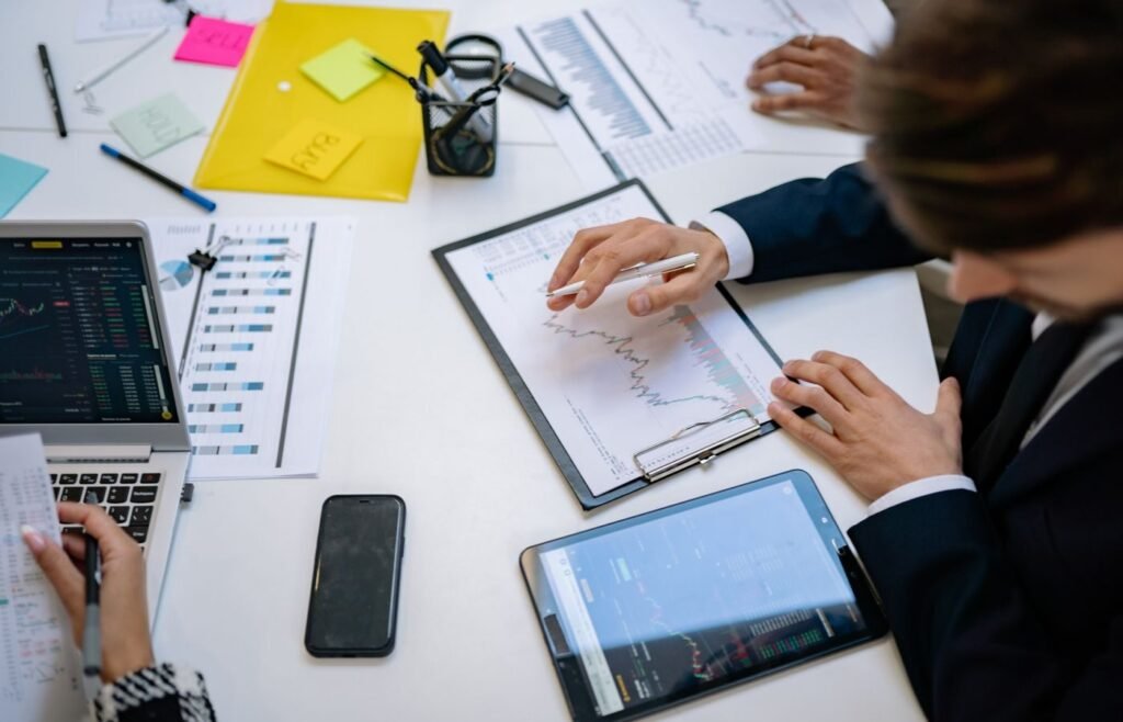 Team reviewing financial charts and channel reporting on tablets in an office