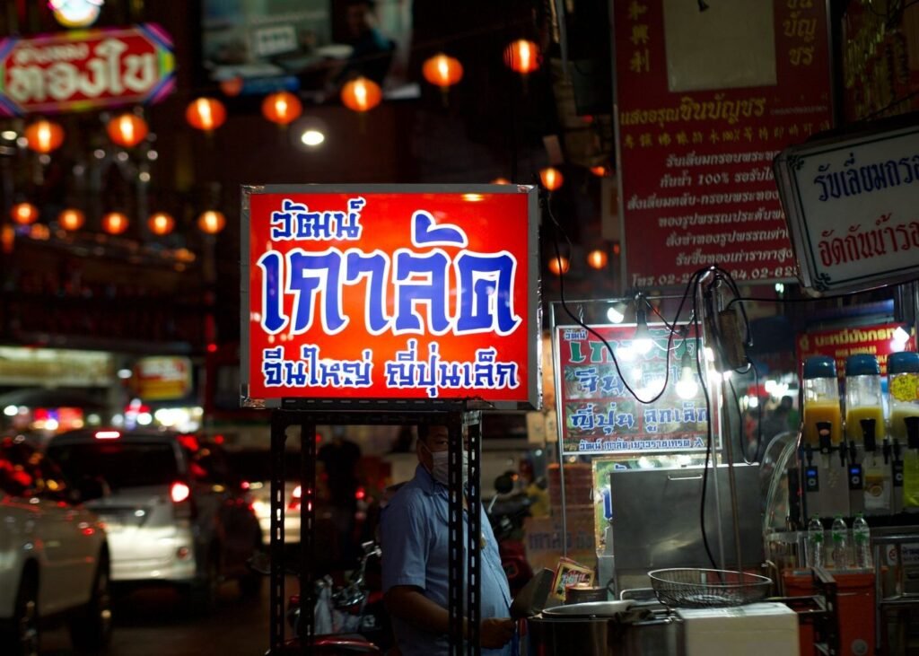 Illuminated shopfront sign during an evening sale period