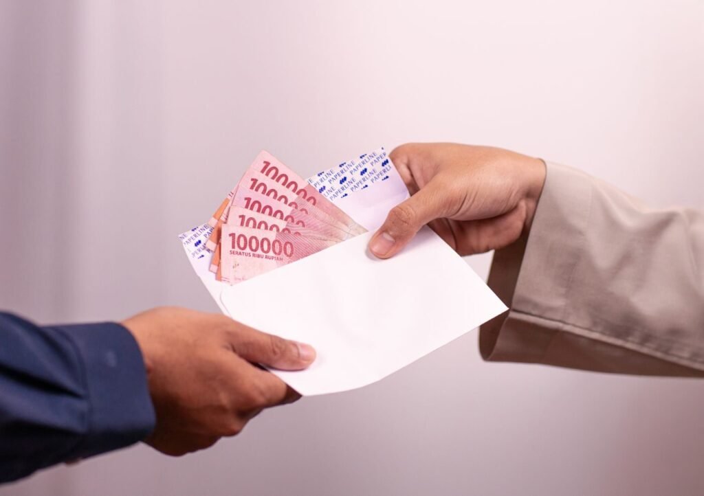 Cash handed over in an envelope on delivery