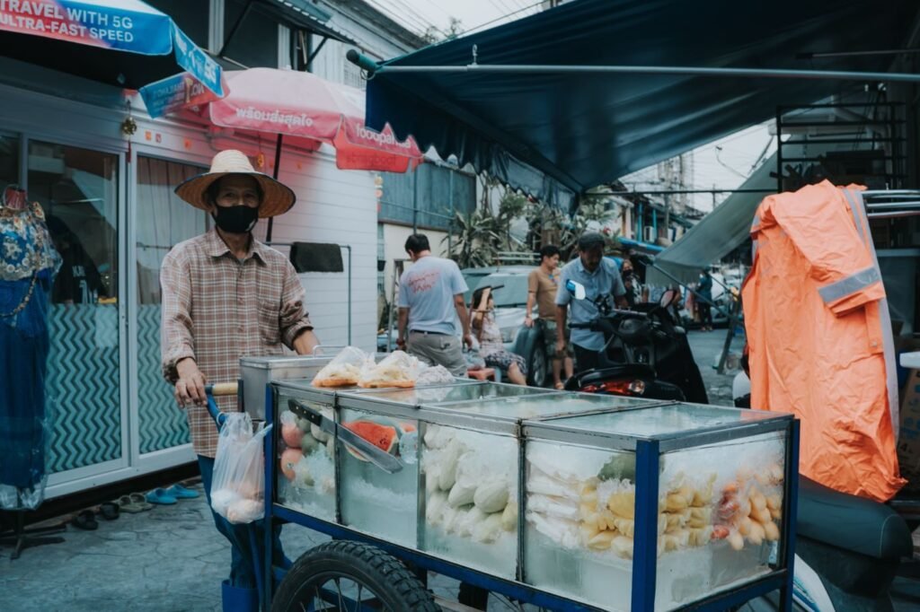 Vendor with a food trolley at a regional bazaar