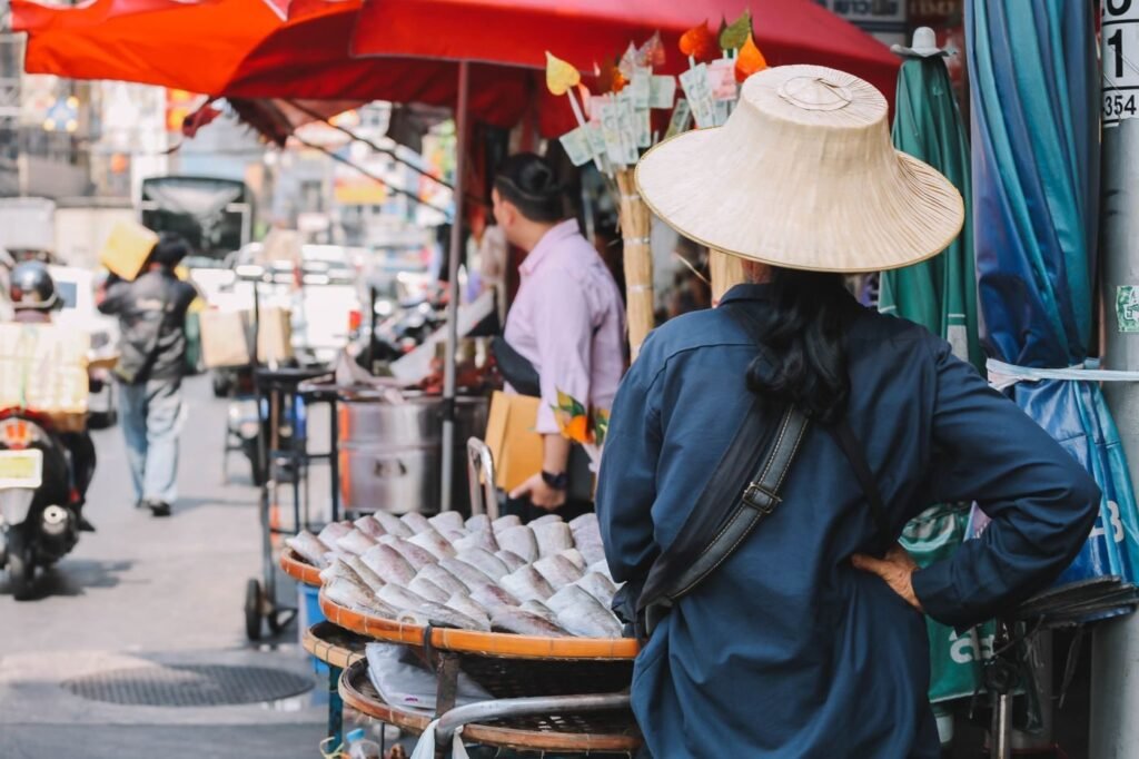 Vendor trading at a bustling Bangkok street market