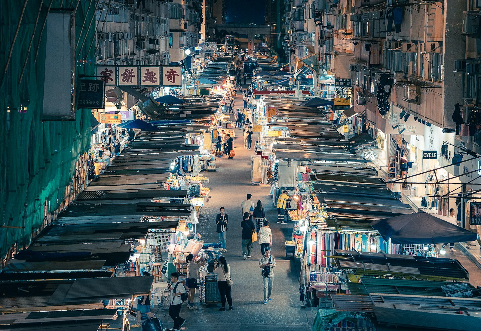 Busy Southeast Asian night market lined with stalls