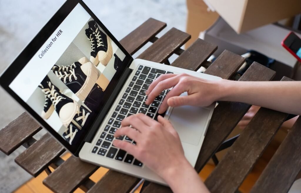 Shopper browsing a collection grid on an online store using a laptop