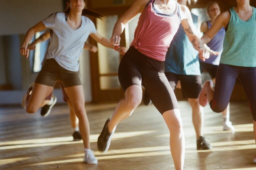 A group running together on a wooden gym floor