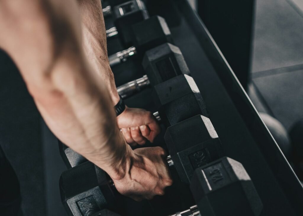 A person training with dumbbells in a gym