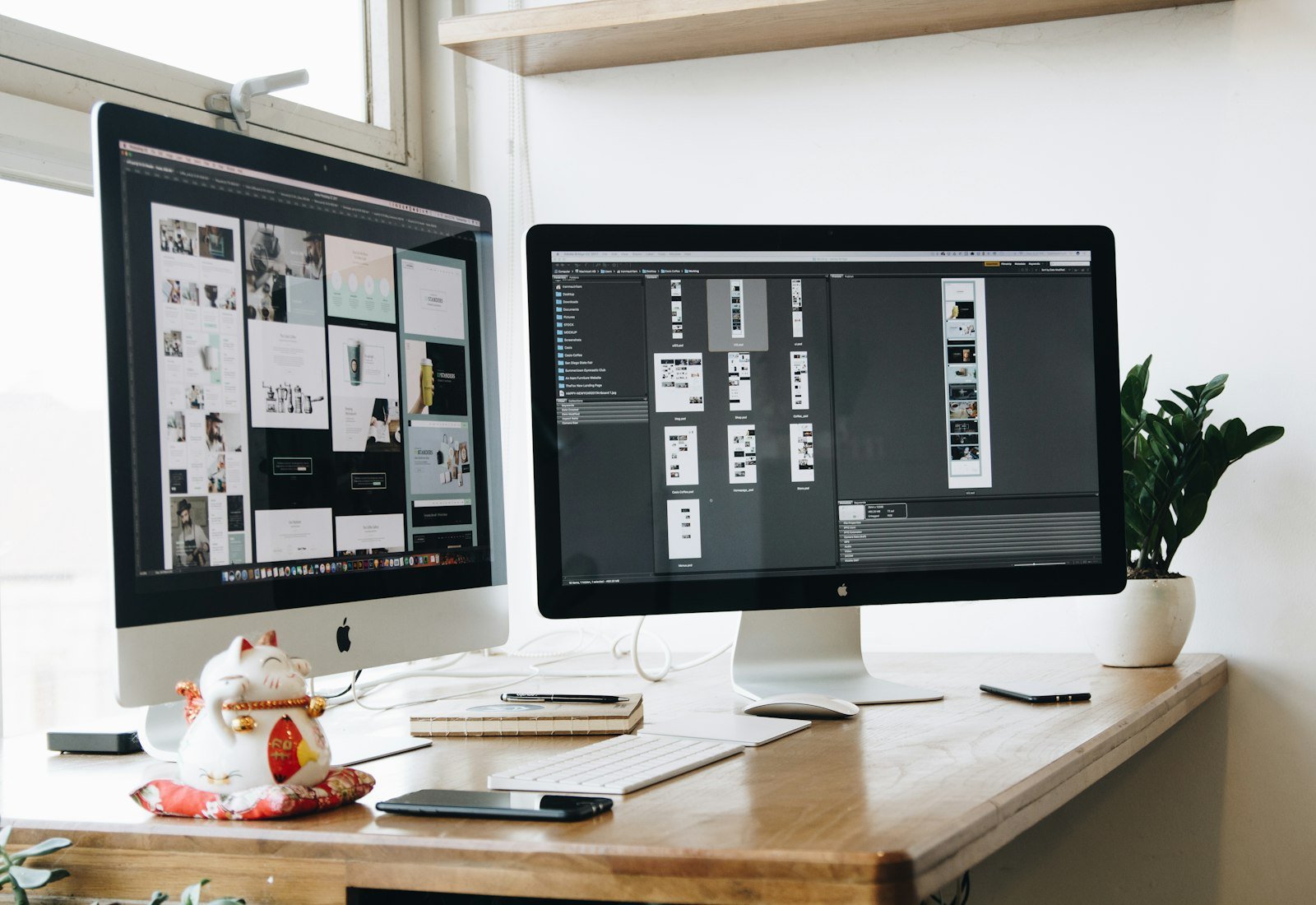Two monitors on a wooden desk in a design studio