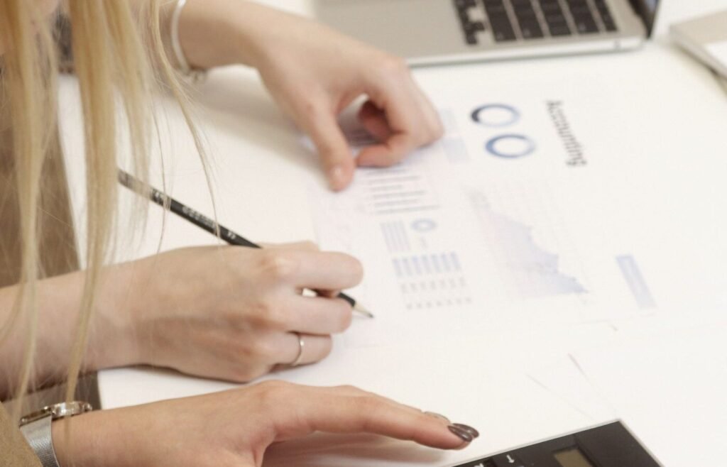 Team reviewing marketing spend and new customer numbers together at a desk