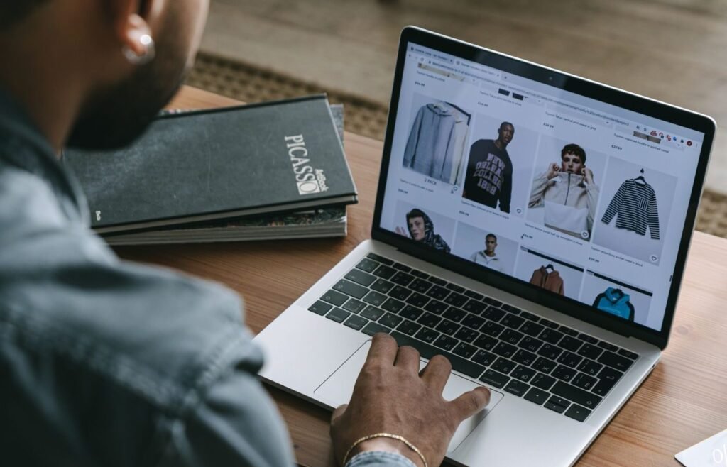 Customer browsing an online shopping site on a laptop before deciding to buy