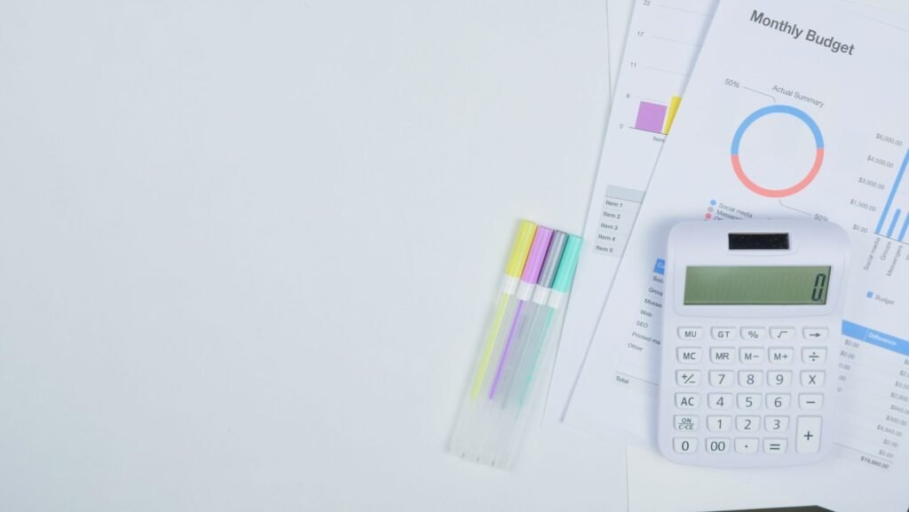 Desk with a calculator and planning documents, modelling what a customer is worth over time