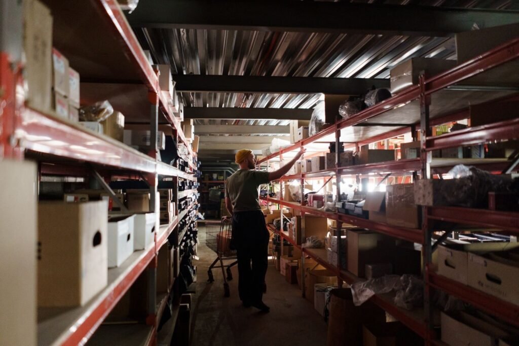 Warehouse operative arranging marketplace stock on shelving