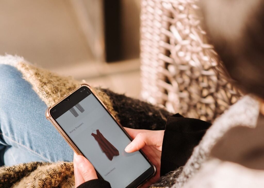 Shopper browsing an online store on a smartphone at home