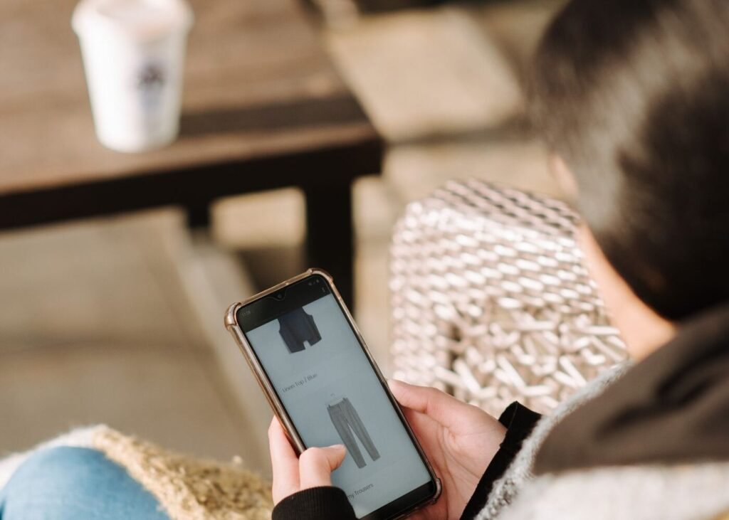 Shopper comparing clothing options in an online store on a laptop
