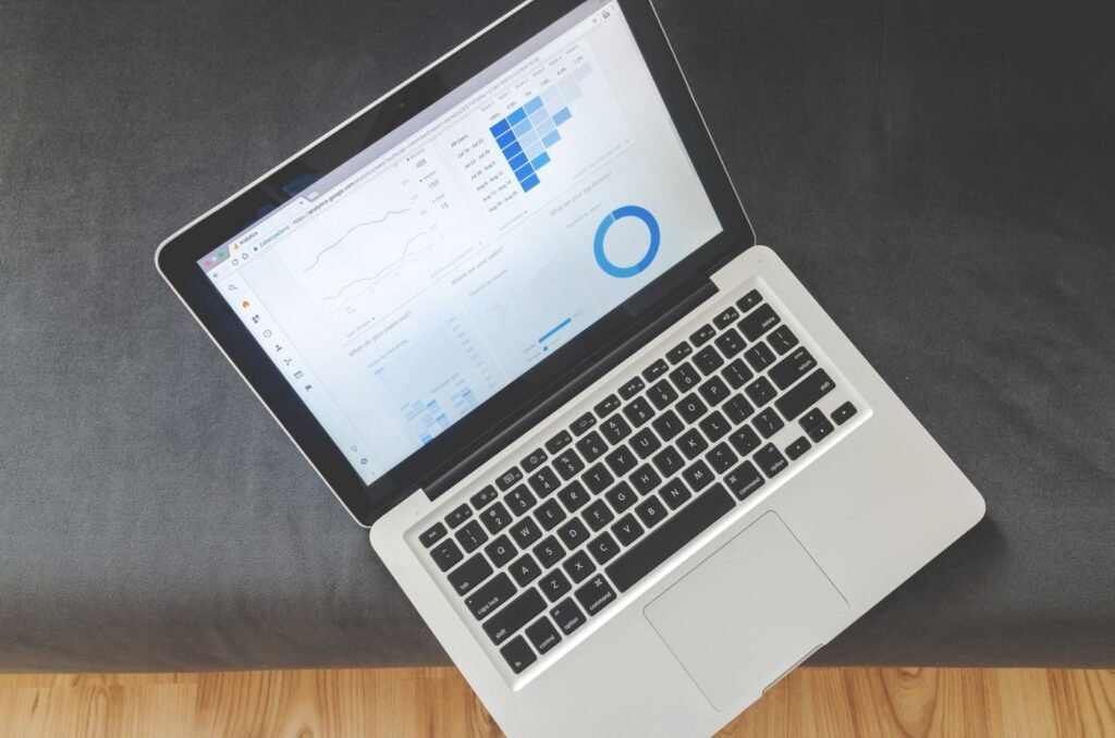 Overhead view of a laptop showing paid media performance charts