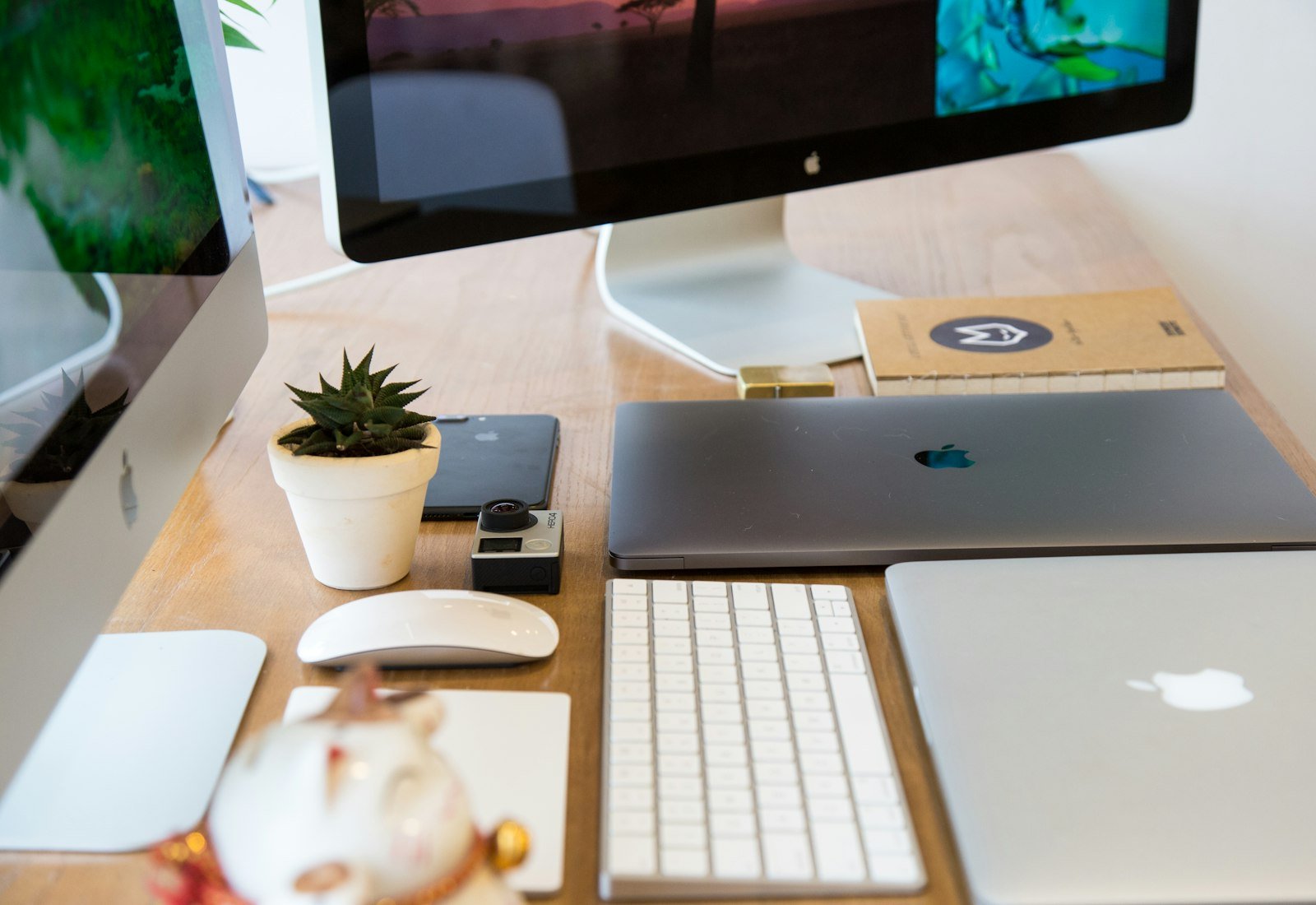 Wooden desk with a monitor and keyboard in a design workspace